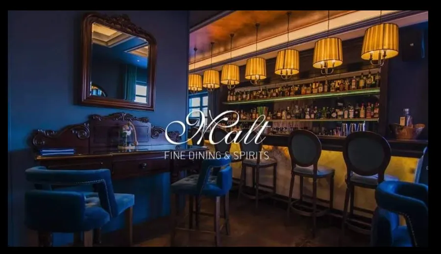 Malt Fine Dining & Spirits — moody bar interior