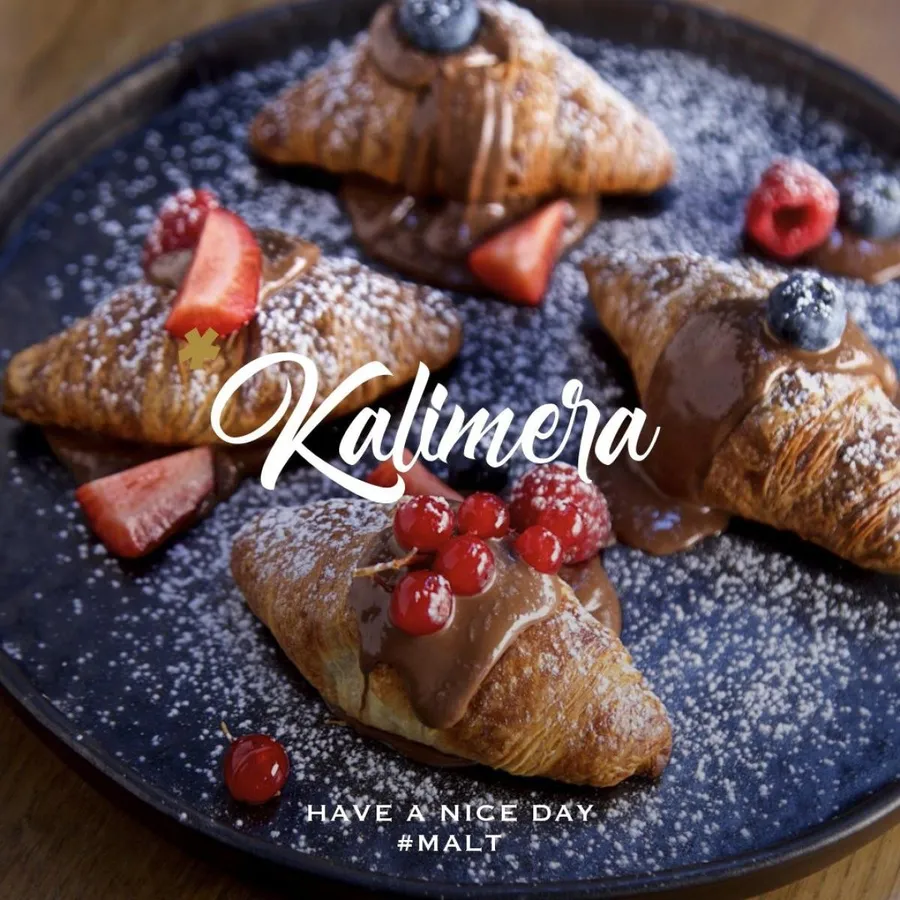 Chocolate-filled croissants with fresh berries and powdered sugar