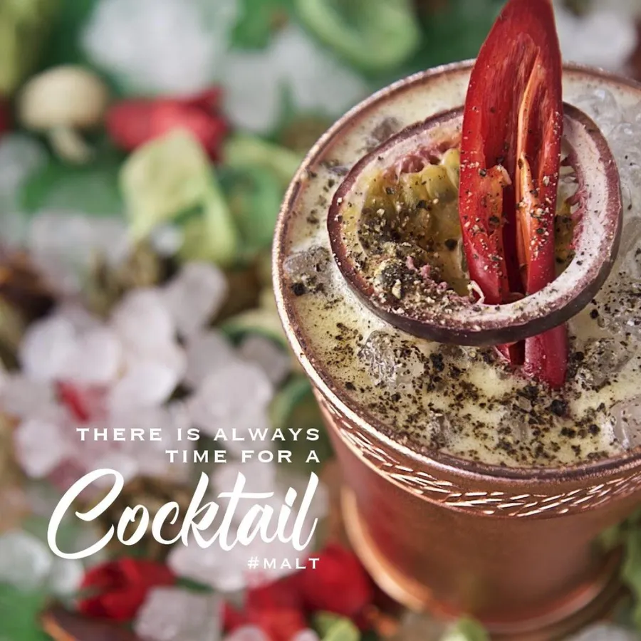 Craft cocktail with a charred citrus garnish