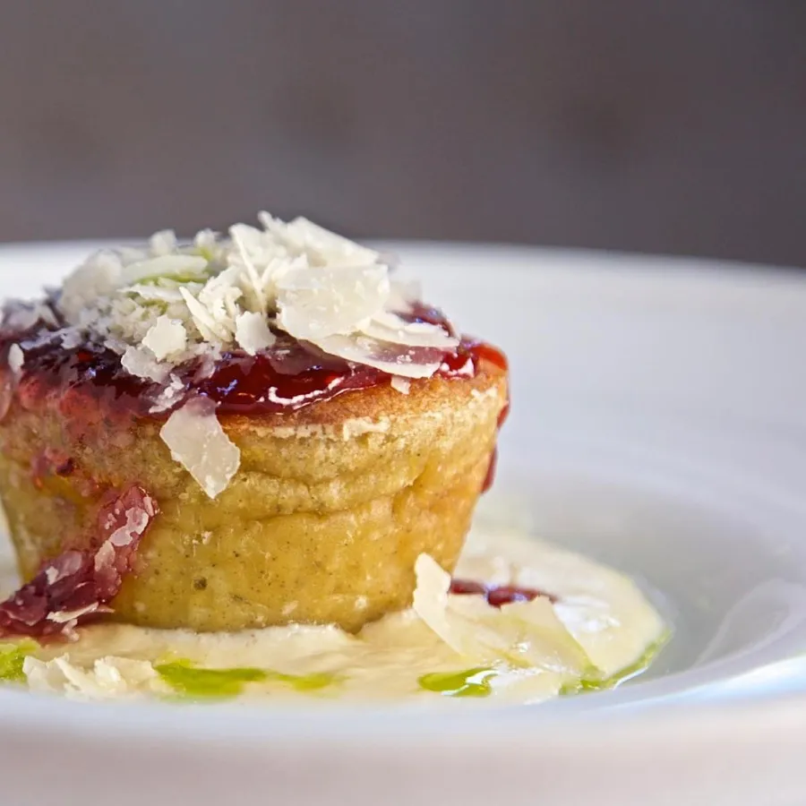 Parmesan soufflé with red fruit sauce and parmesan cream