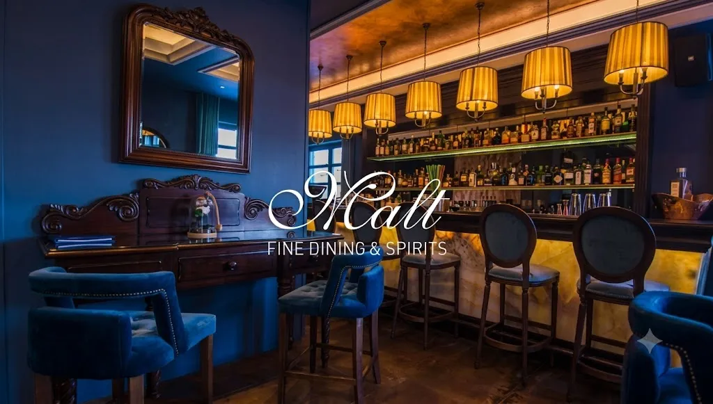Malt Fine Dining & Spirits — moody bar interior with the Malt logo